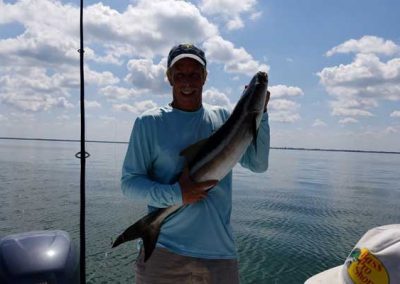Man holding huge cobia caught from gulf of mexico. Fishing florida flats.